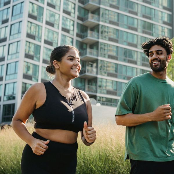 Smiling person feeling energetic and happy after a workout session outdoors.